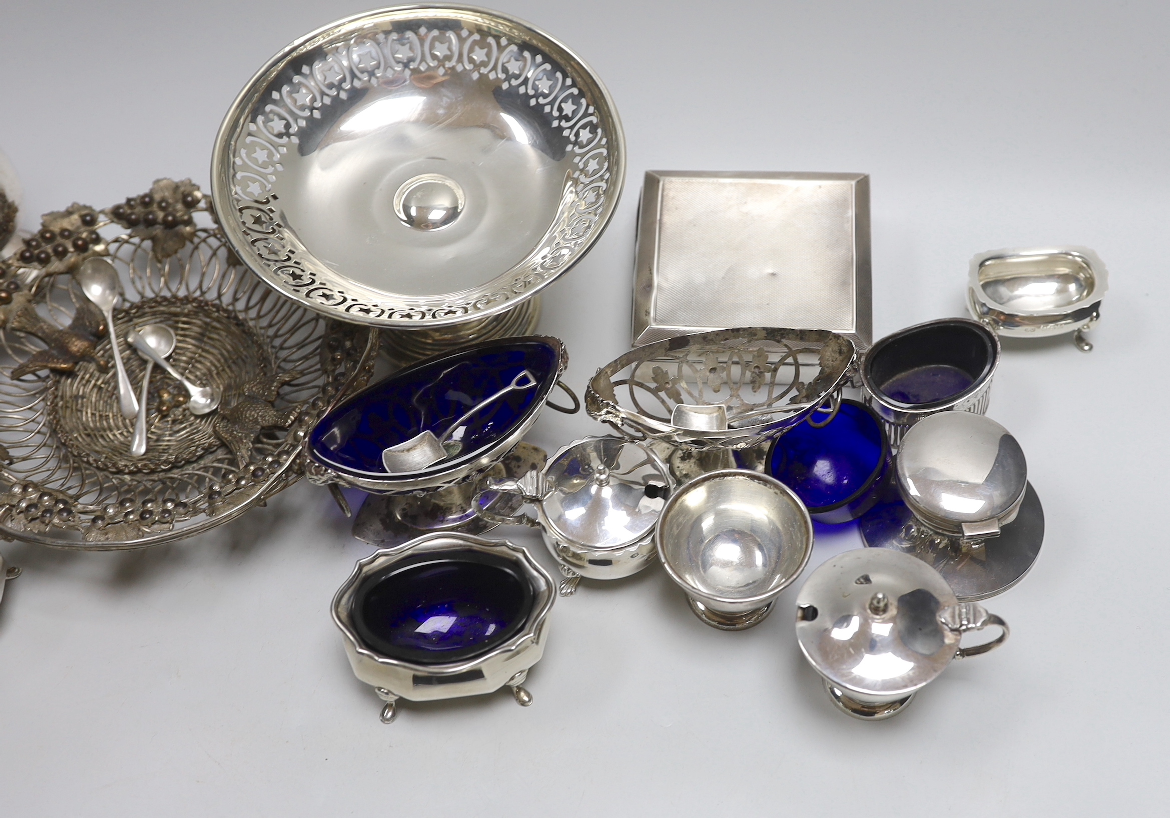 Assorted silver etc, including a George III sparrow beak cream jug, Thomas & Richard Payne, London, 1779, condiments, cigarette box, weighted tazze, etc.